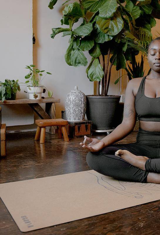 Woman on Scoria Cork yoga Mat meditating